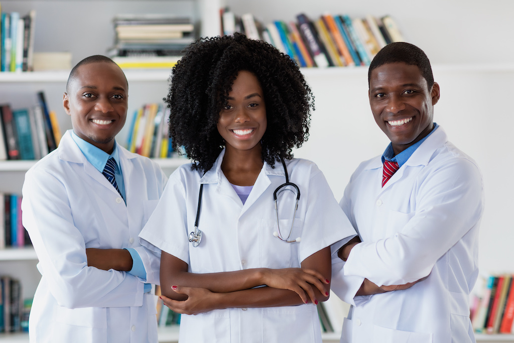 General practitioner and doctor and nurse as african american medical team at hospital